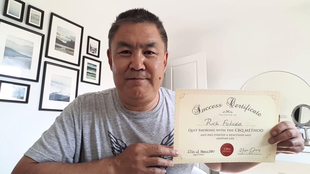 Rick Fukuda holding his CBQ Quit Smoking Success Certificate