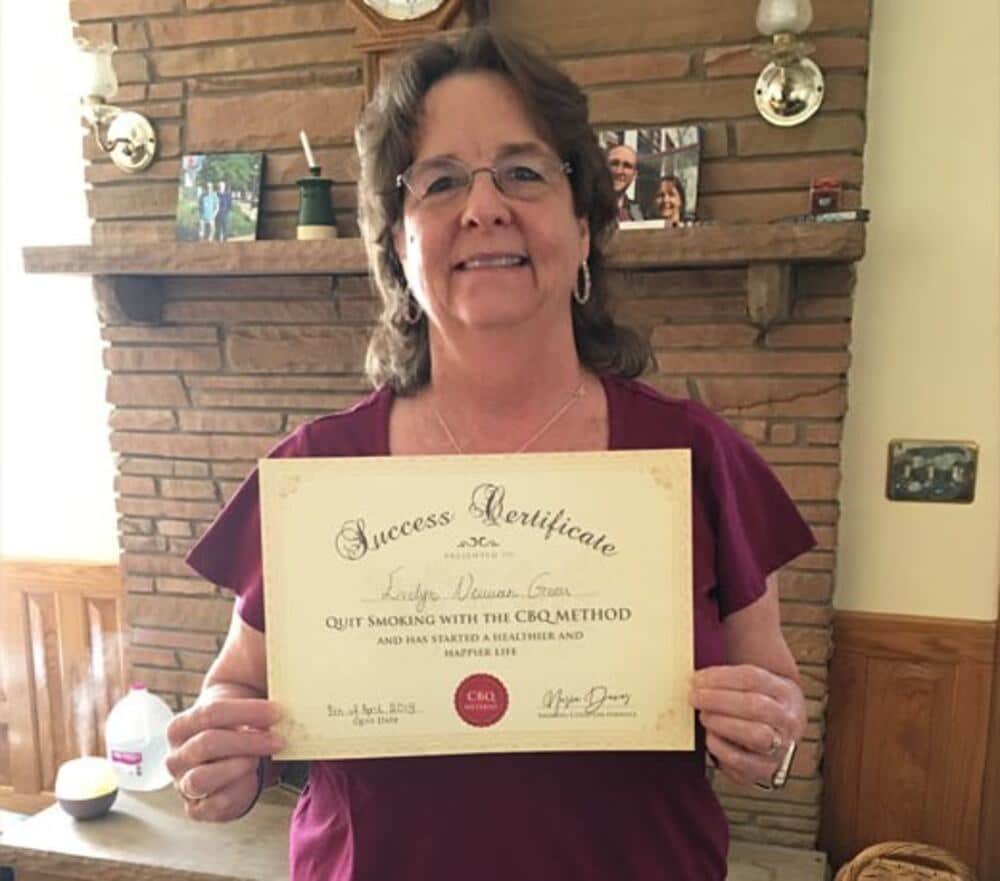 Evelyn Green holding her CBQ Success Certificate