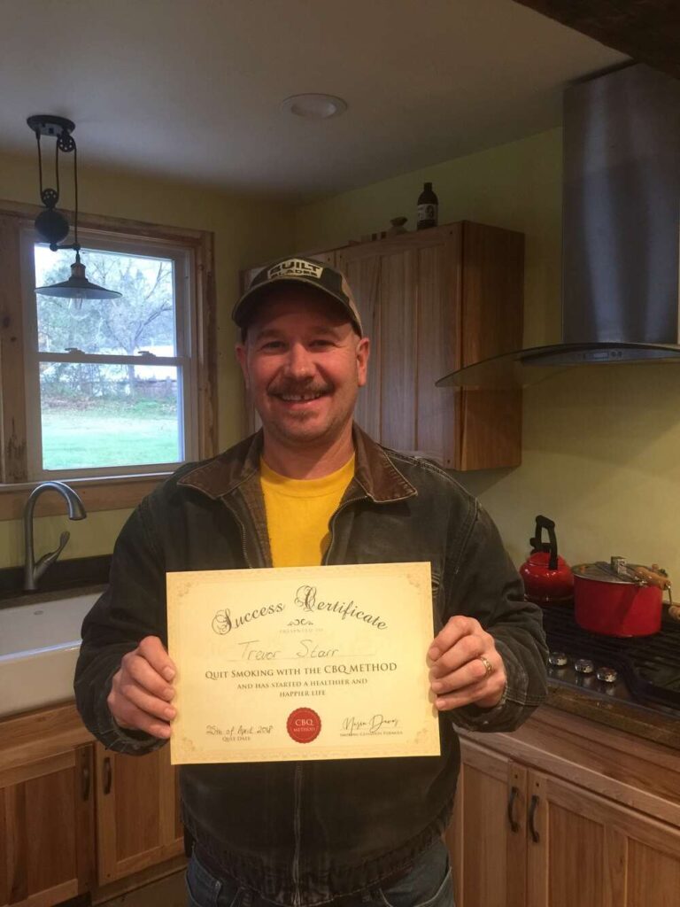Trevor Starr holding his CBQ Success Certificate