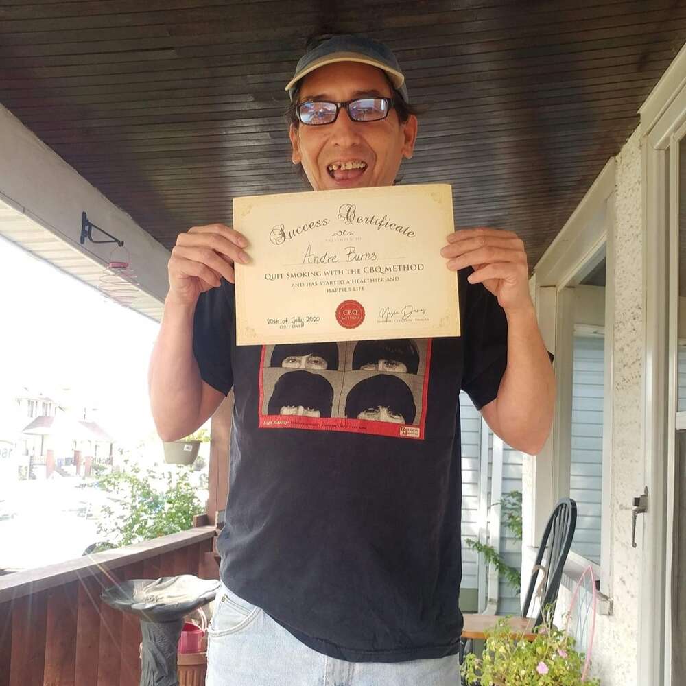 Andre Burns holding his CBQ Success Certificate