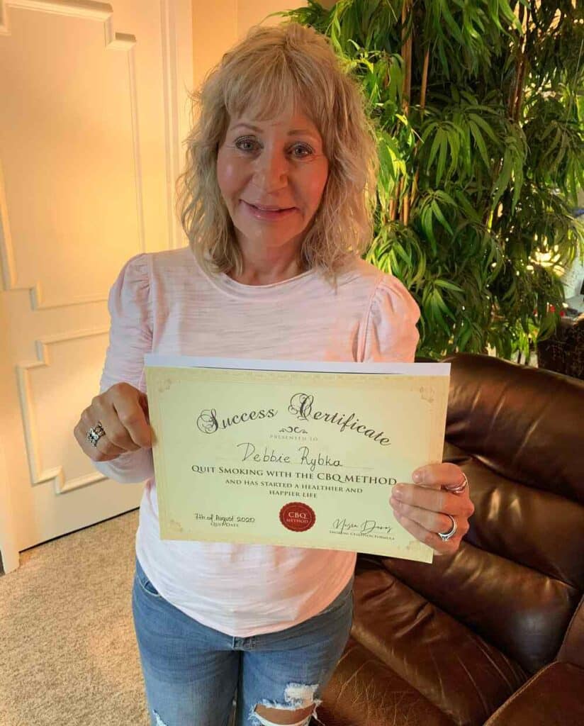 Debbie Rybka holding her CBQ Success Certificate