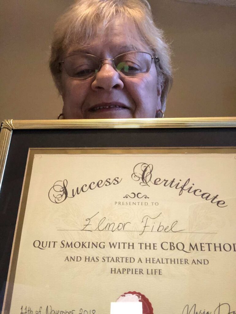 Elinor Fibel holding her CBQ Success Certificate