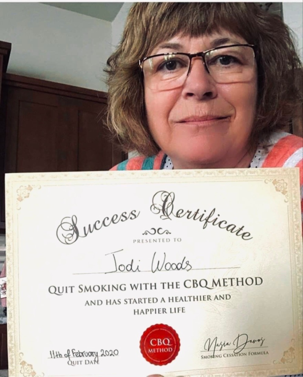 Jodi Woods holding her CBQ Success Certificate