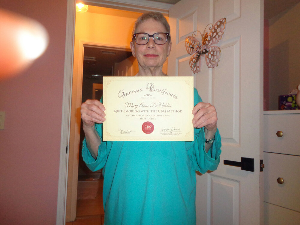 Mary Anne Dinublia holding her CBQ Success Certificate