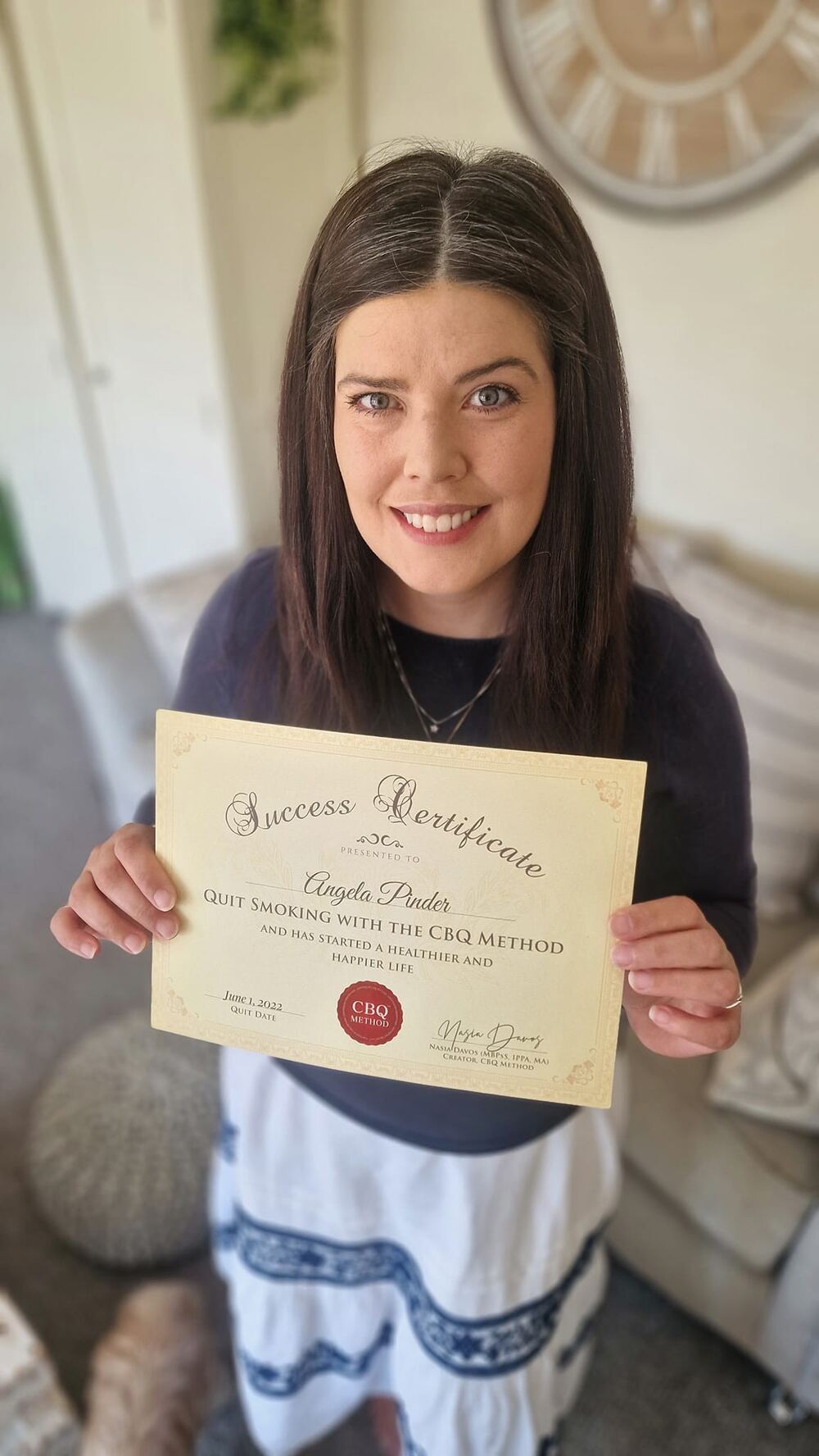 Angela Pinder holding her CBQ Success Certificate