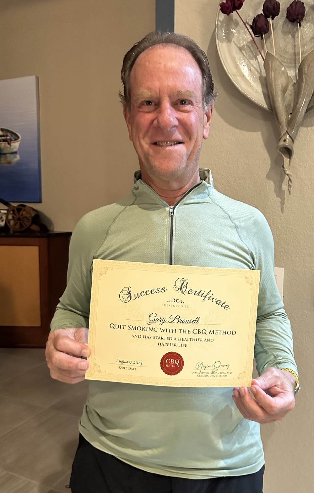 Gary Brousell holding his CBQ Success Certificate
