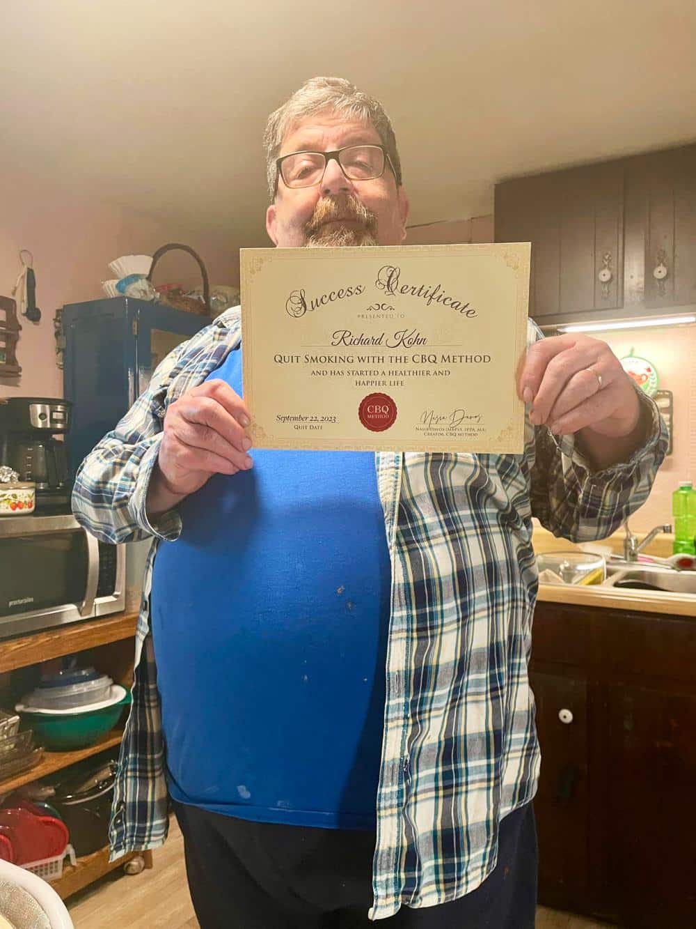 Richard Kohn holding his CBQ Success Certificate