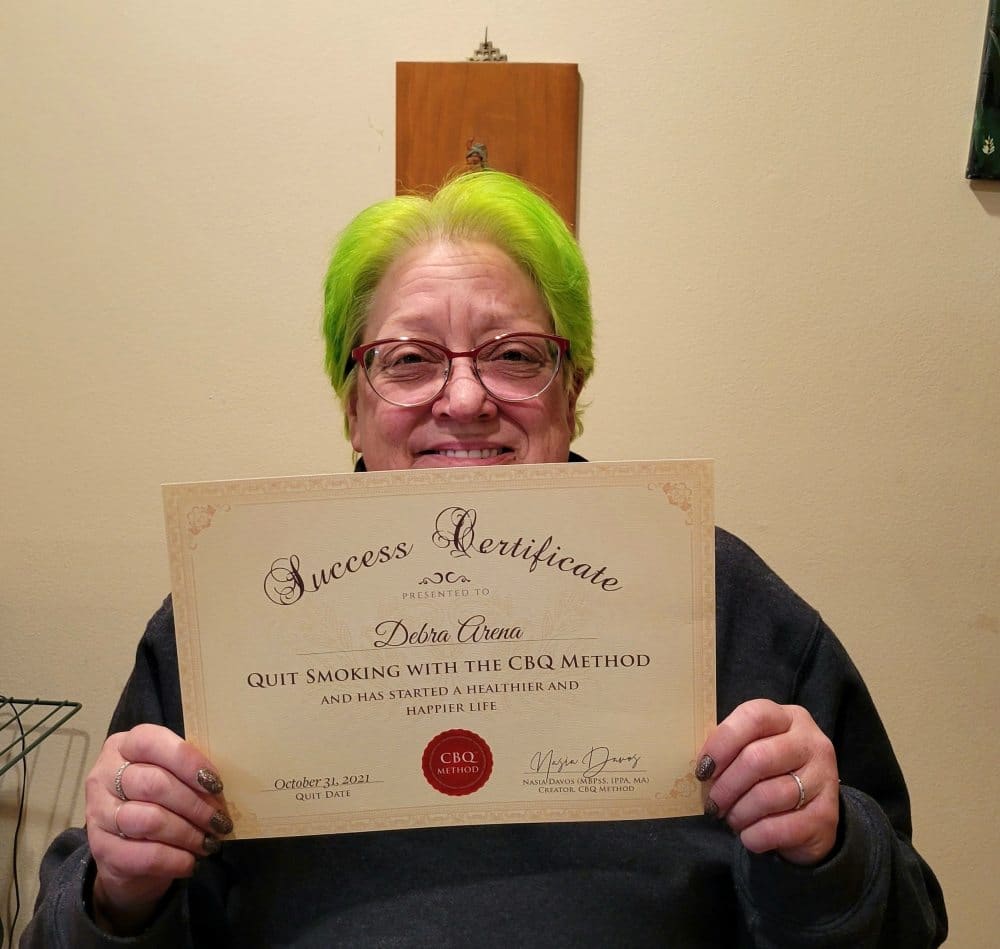 Debra Arena holding her CBQ Success Certificate