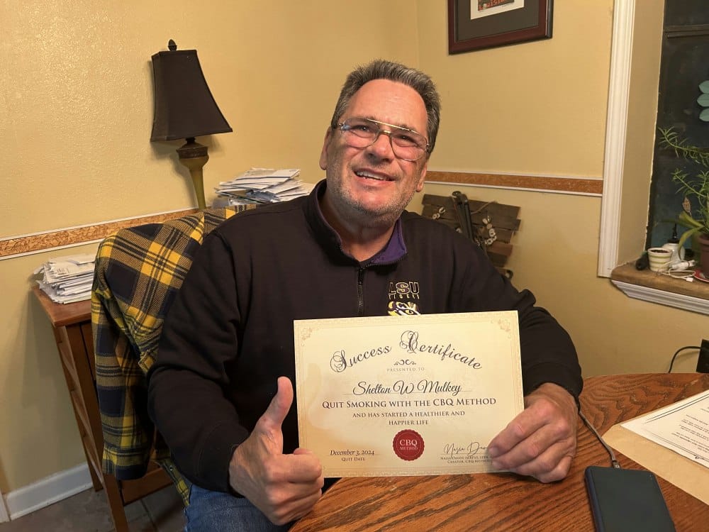 Shelton Mulkey holding his CBQ Success Certificate