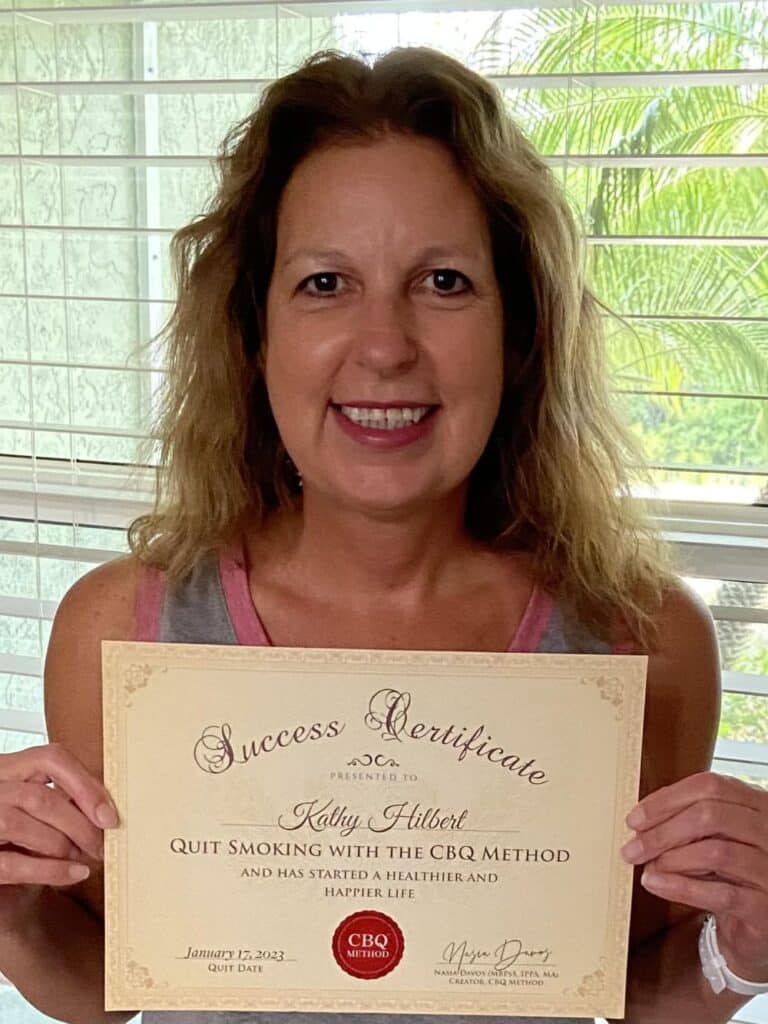 Kathy Hilbert holding her CBQ Freedom Certificate
