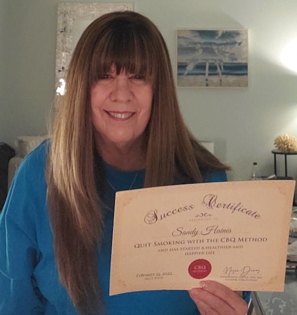 Sandy Holding Her CBQ Success Certificate