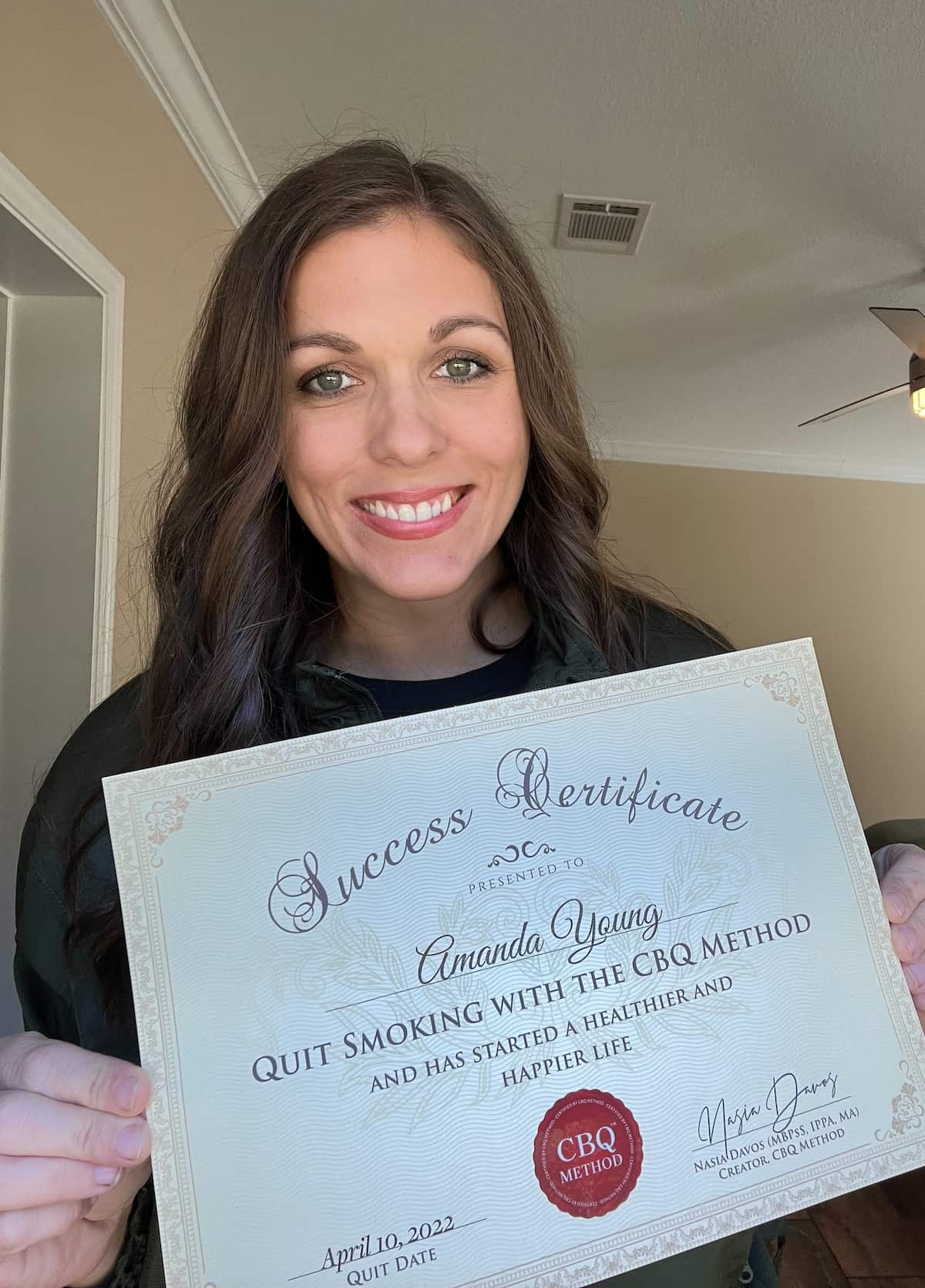 CBQ Nicotine Freedom Program member Amanda Young Holding Her CBQ Success Certificate
