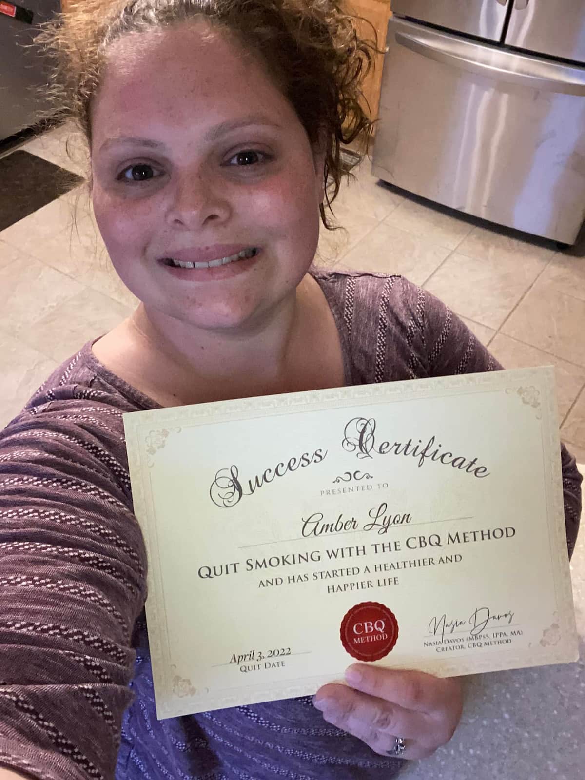 CBQ Quit Smoking Program Amber Lyon Morton Holding Her CBQ Success Certificate
