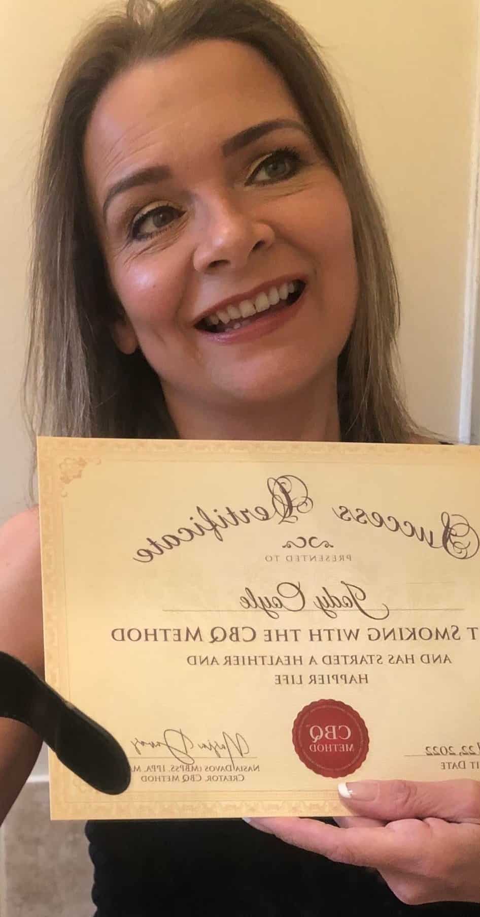 CBQ Nicotine Freedom Program member Jody Coyle holding her CBQ Success Certificate
