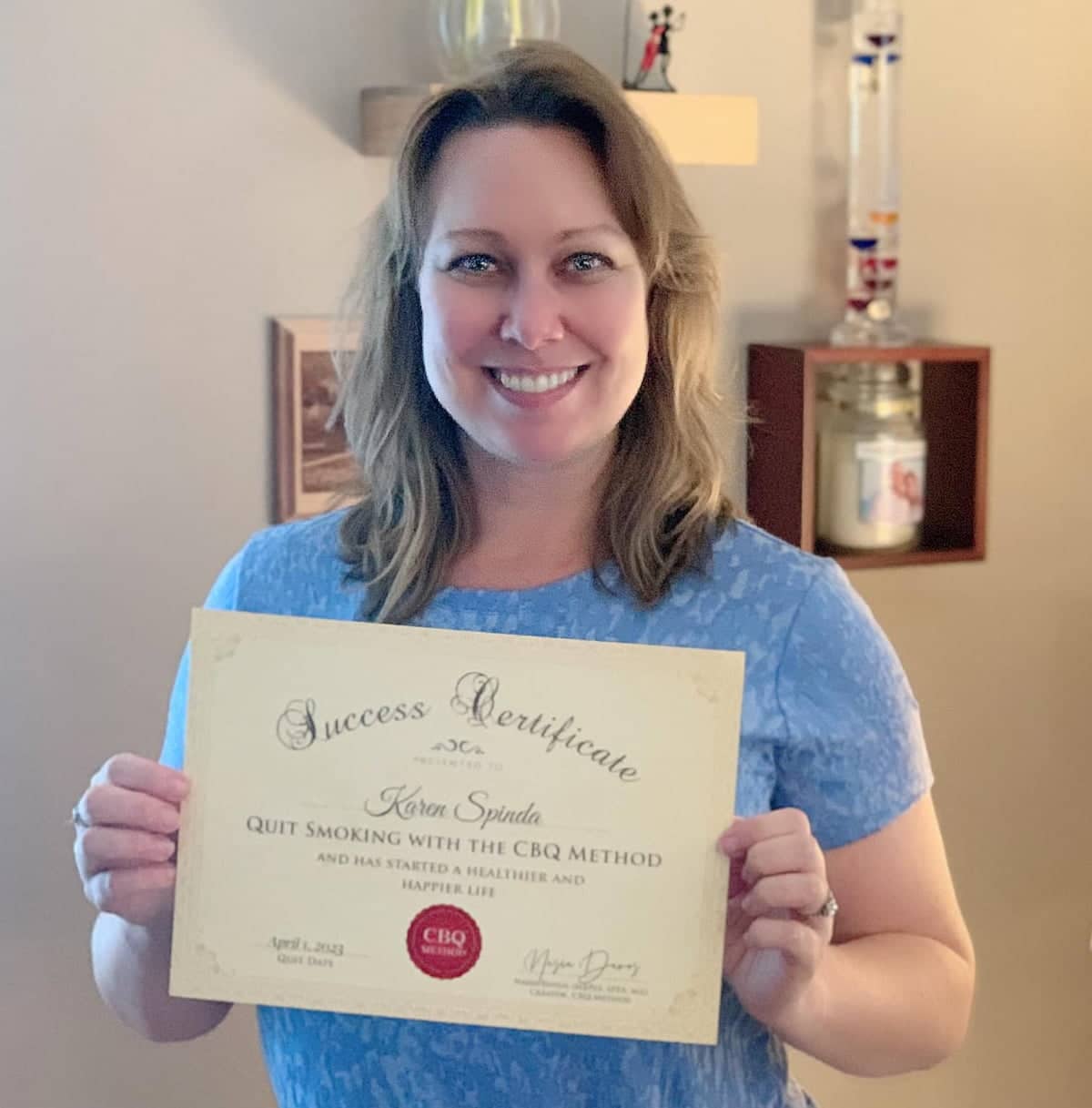 CBQ Nicotine Freedom Member Karen Spinda Holding Her CBQ Success Certificate