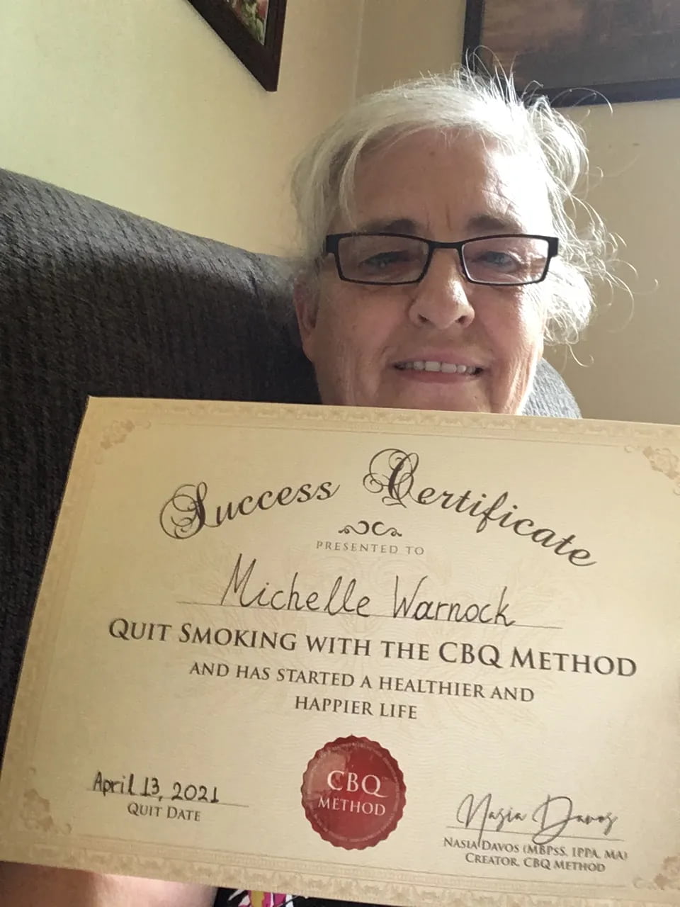 CBQ Nicotine Freedom Program member Michelle Warnock Holding Her CBQ Success Certificate
