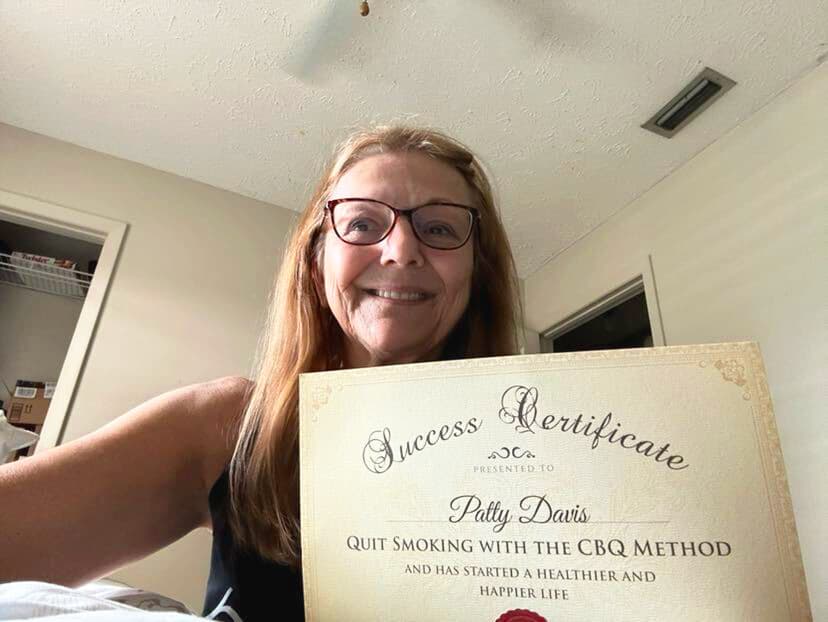 CBQ Nicotine Freedom Program member Patty Davis holding her CBQ Success Certificate