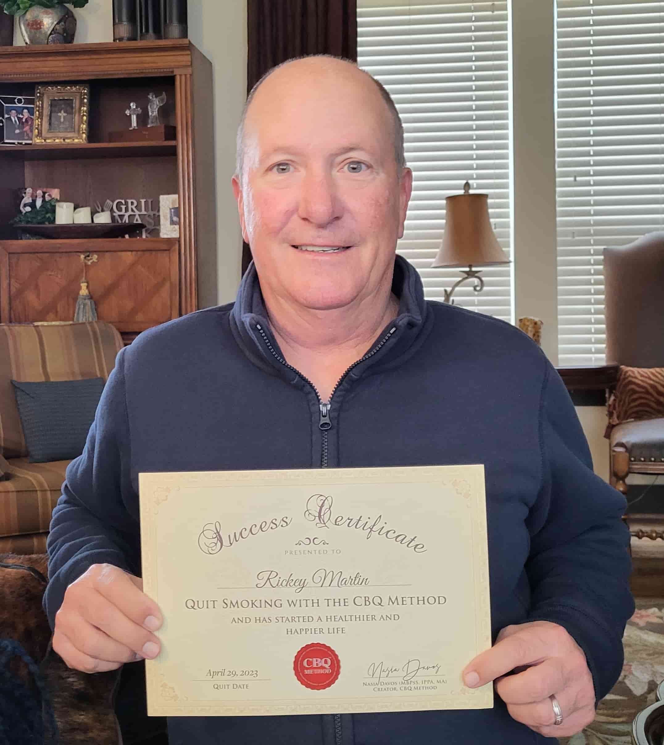 CBQ Nicotine Freedom Program member Rickey Martin holding his CBQ Success Certificate