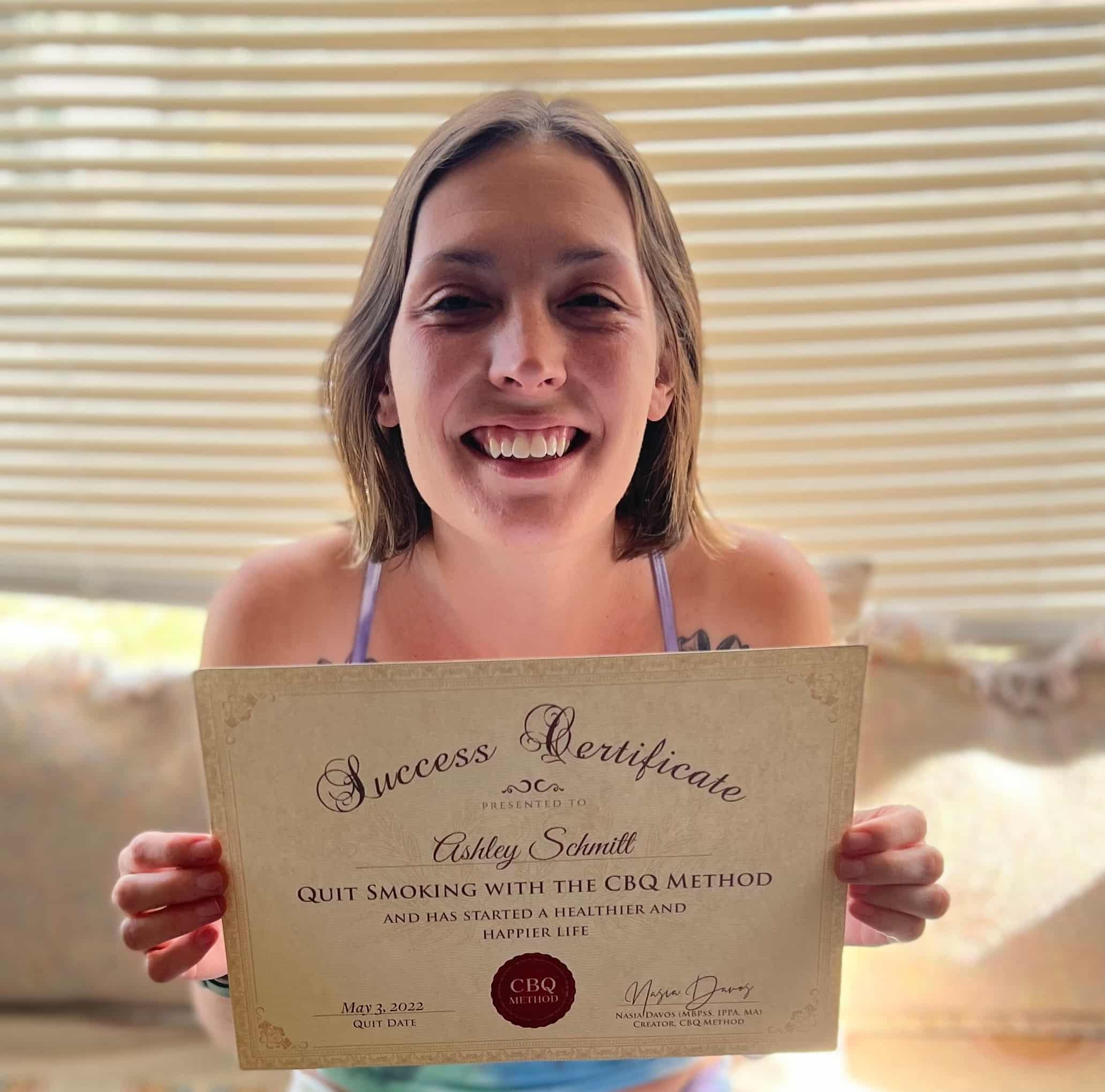 CBQ Nicotine Freedom Program member Ashley Schmitt holding her CBQ Success Certificate