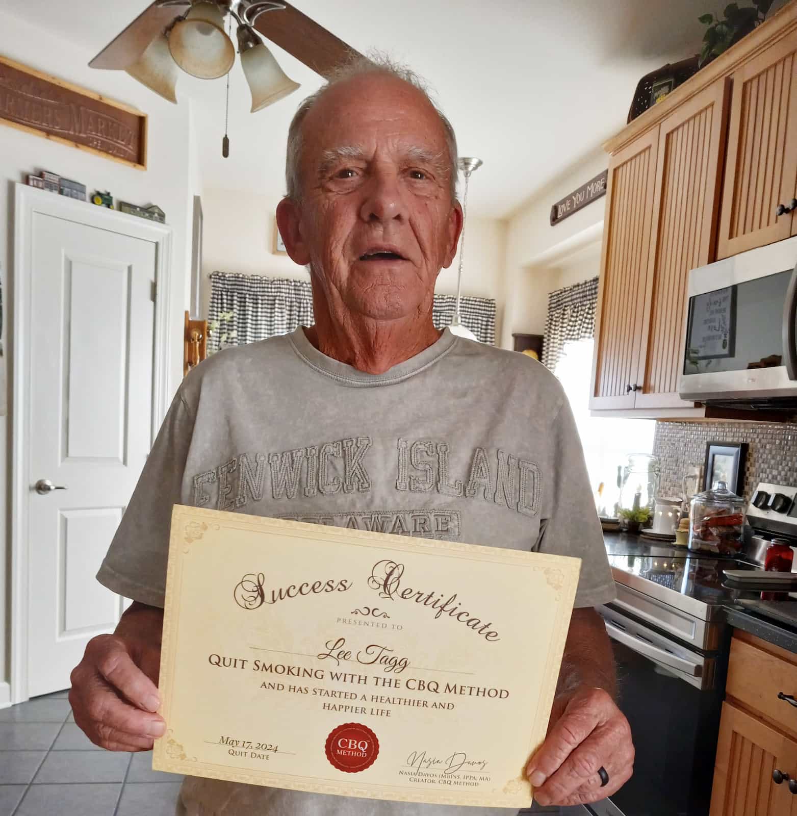 CBQ Nicotine Freedom Program member Lee Tagg holding his CBQ Success Certificate