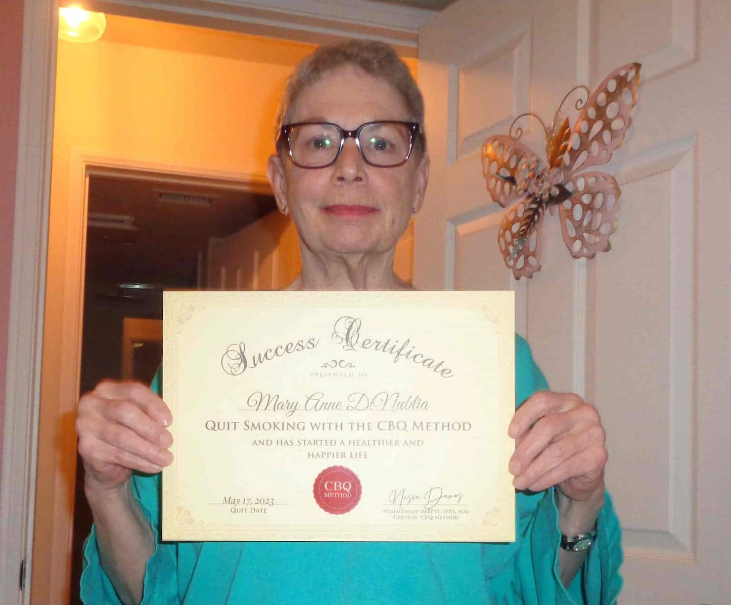CBQ Nicotine Freedom Program member Mary Anne DiNublia holding her CBQ Success Certificate