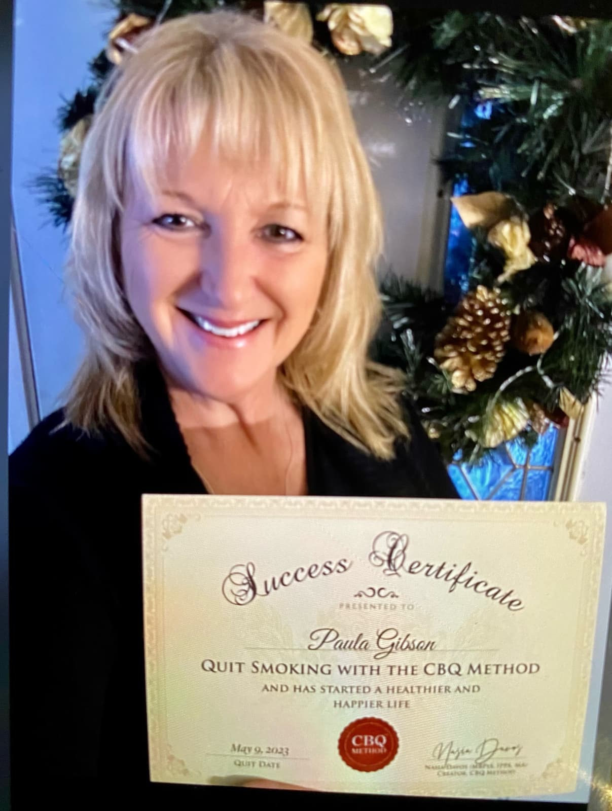 CBQ Nicotine Freedom Program member Paula Gibson holding her CBQ Success Certificate