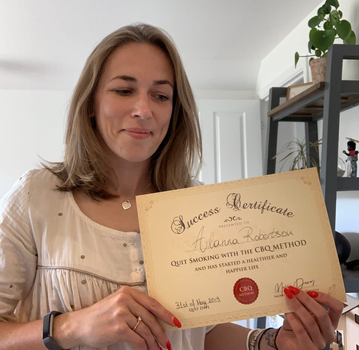 CBQ Nicotine Freedom Program member Alanna Robertson holding her CBQ Success Certificate