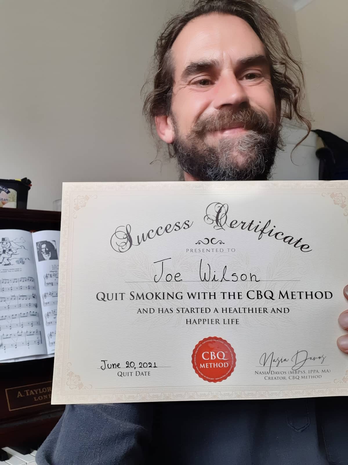 CBQ Nicotine Freedom Program member Joe Wilson holding his CBQ Success Certificate