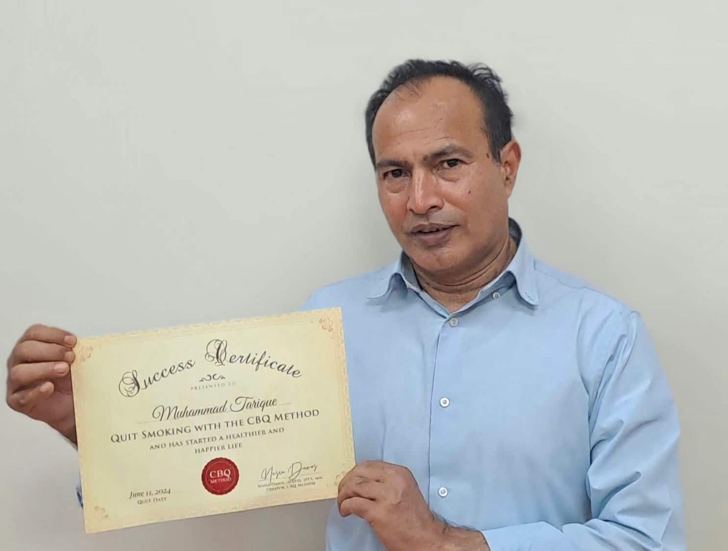 CBQ Nicotine Freedom Program Muhammad Tarique holding his CBQ Success Certificate