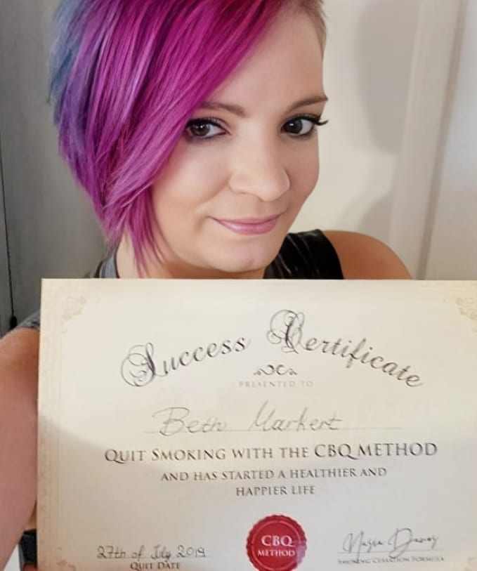 CBQ Nicotine Freedom Program member Beth Markert holding her CBQ Success Certificate