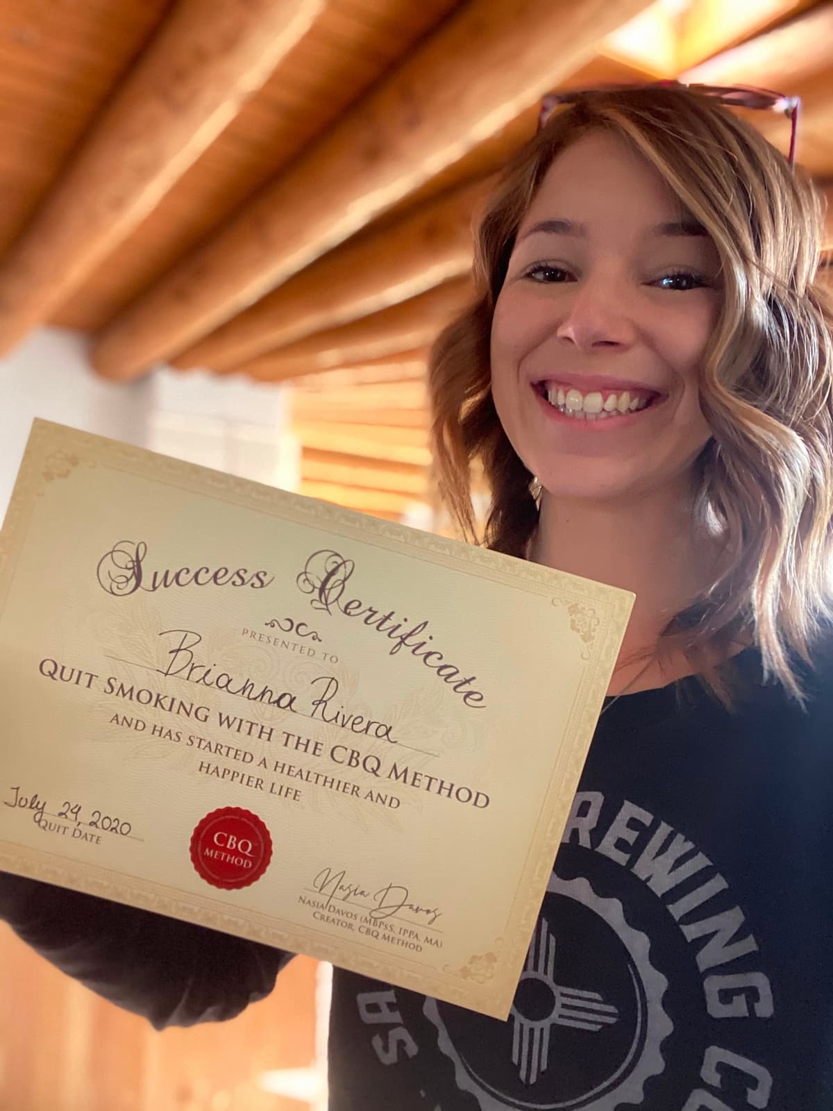 CBQ Nicotine Freedom Program member Brianna Rivera holding her CBQ Success Certificate