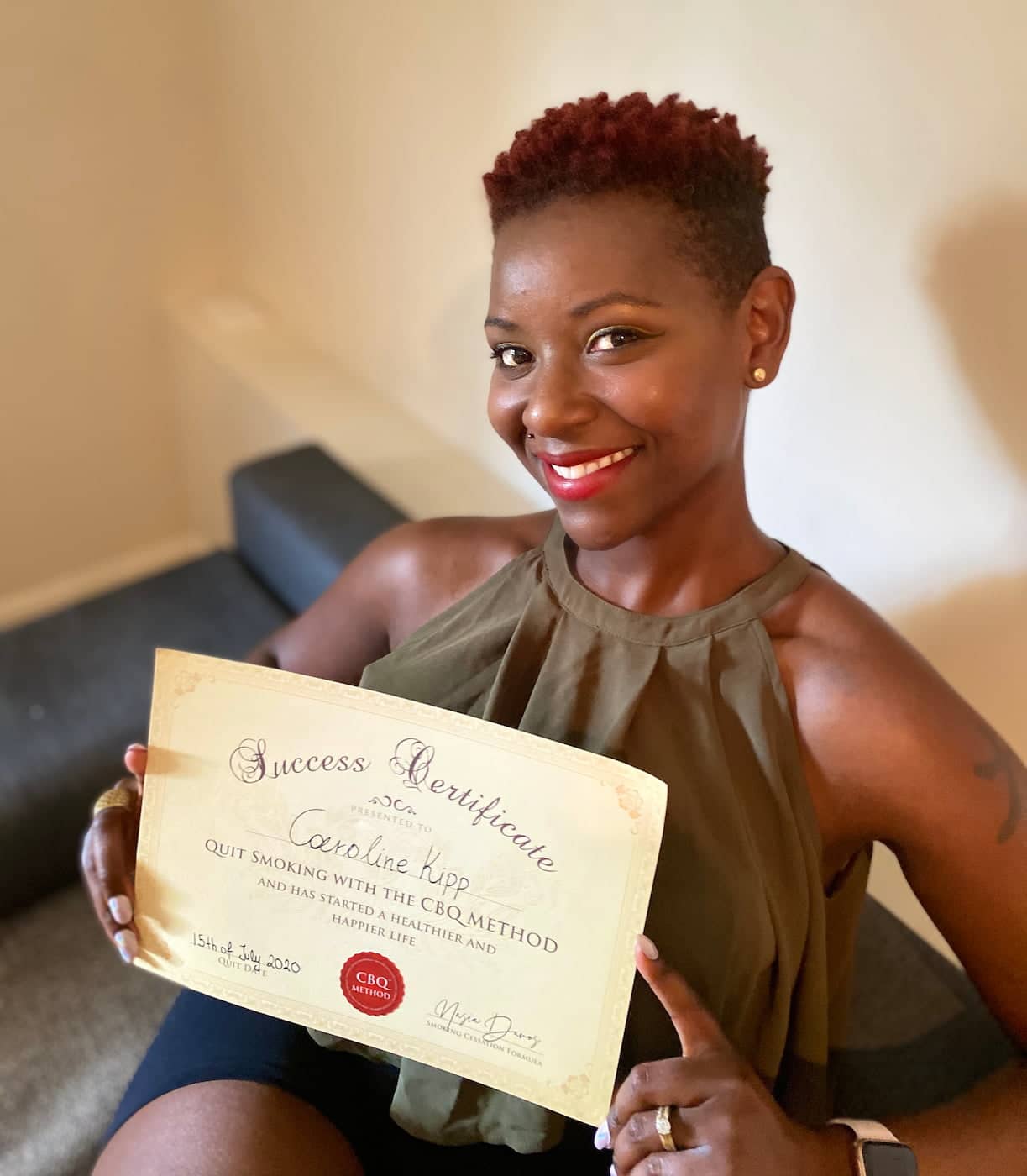 CBQ Nicotine Freedom Program member Caroline Kipp holding her CBQ Success Certificate