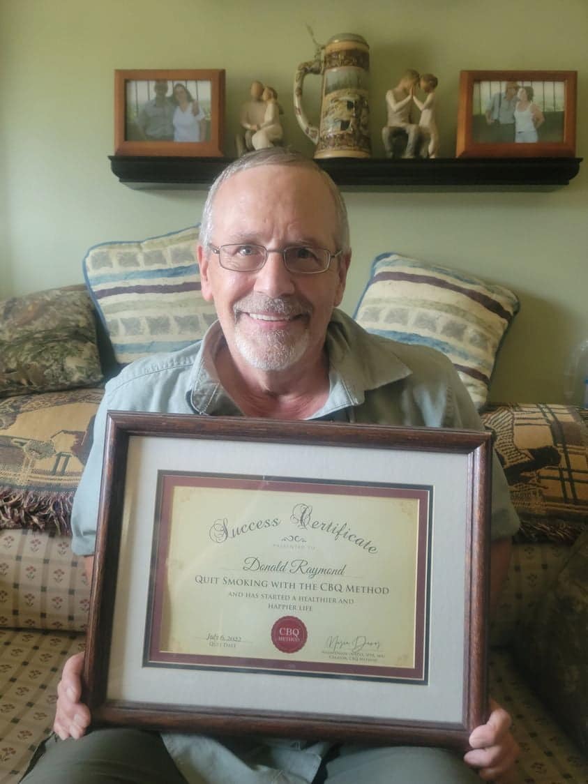 CBQ Nicotine Freedom Program member Donald Raymond holding his CBQ Success Certificate