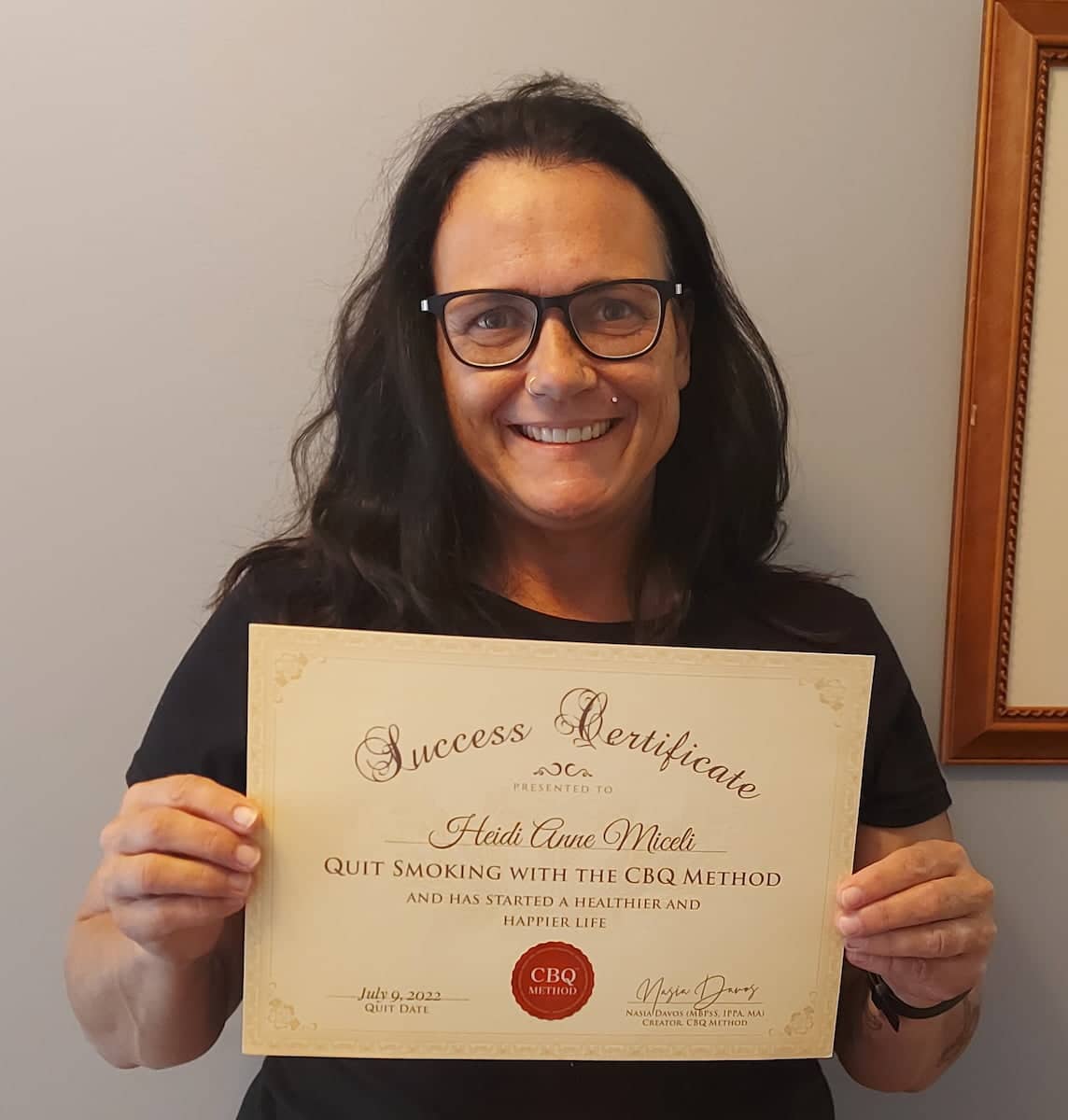CBQ Nicotine Freedom Program member Heidi Anne Miceli holding her CBQ Success Certificate