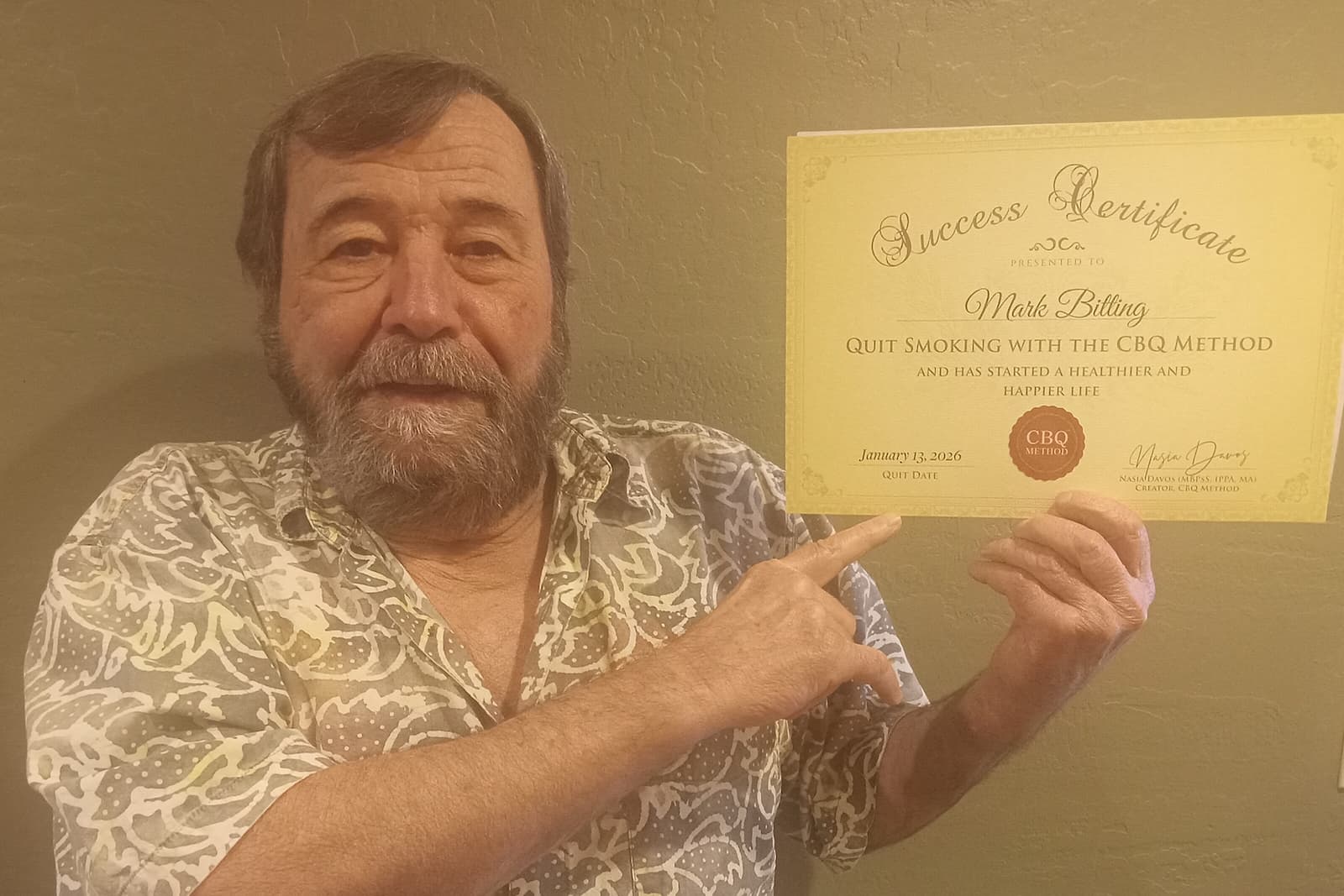 CBQ Nicotine Freedom Program member Mark Bitting holding his CBQ Success Certificate