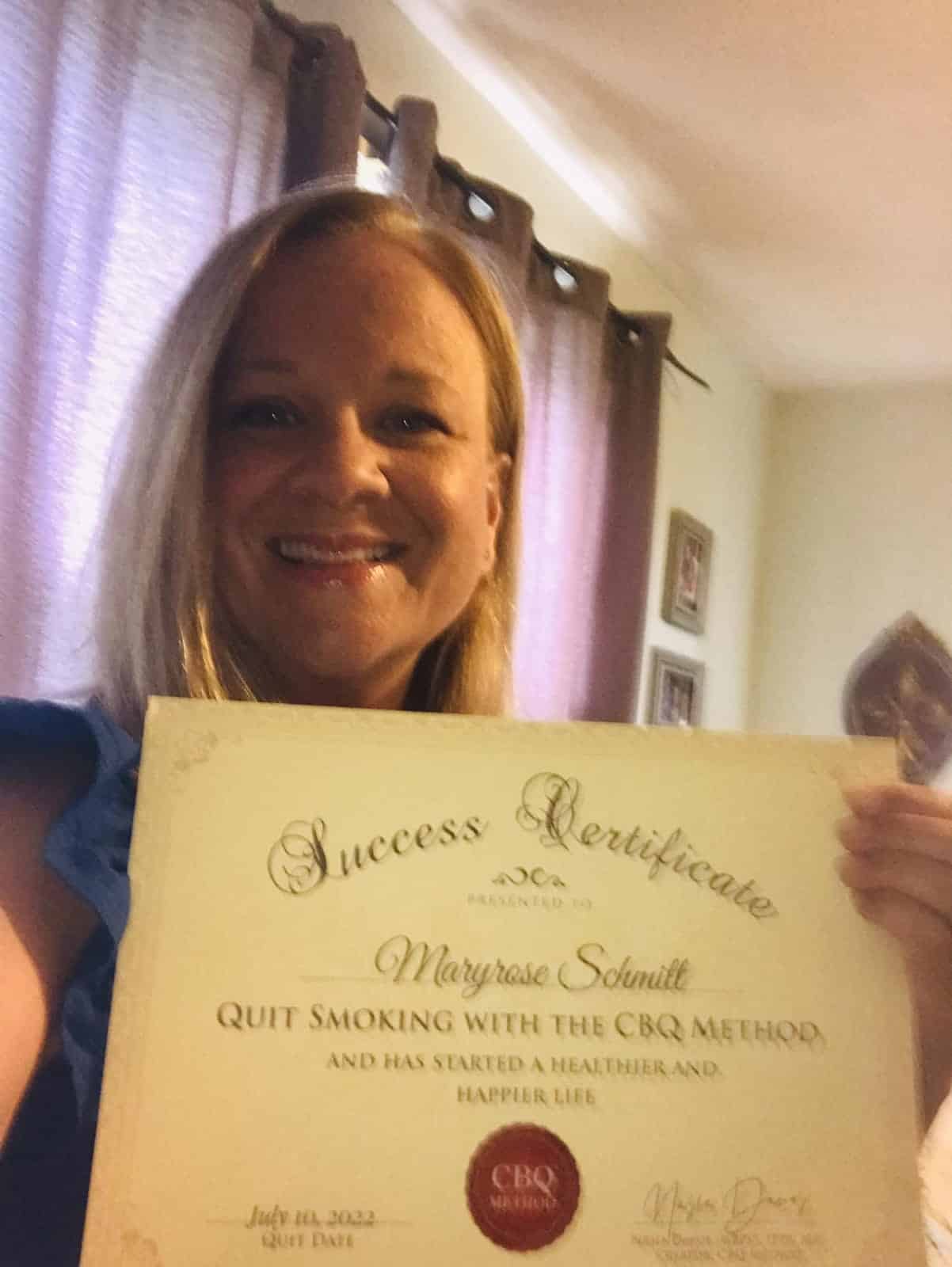 CBQ Nicotine Freedom Program member Maryrose Schmitt holding her CBQ Success Certificate