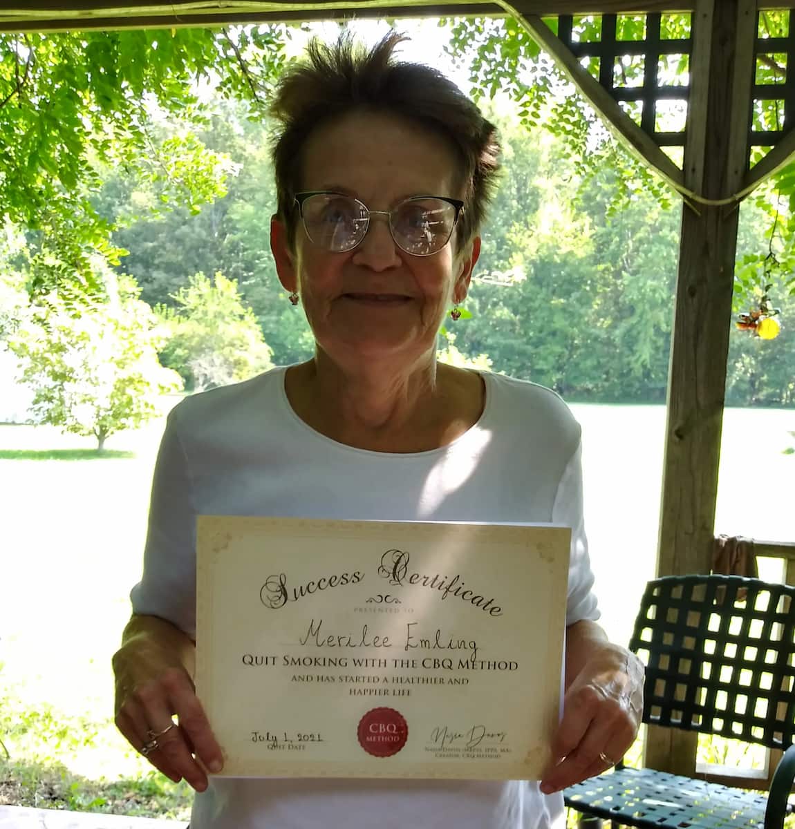 CBQ Nicotine Freedom program member Merilee Emling holding her CBQ Success Certificate