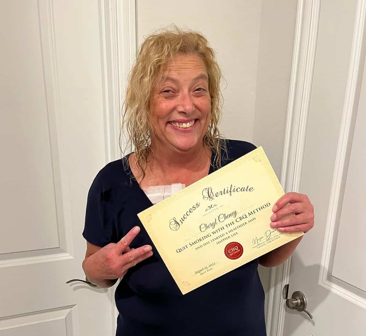 CBQ Nicotine Freedom Program member Cheryl Cheney holding her CBQ Success Certificate