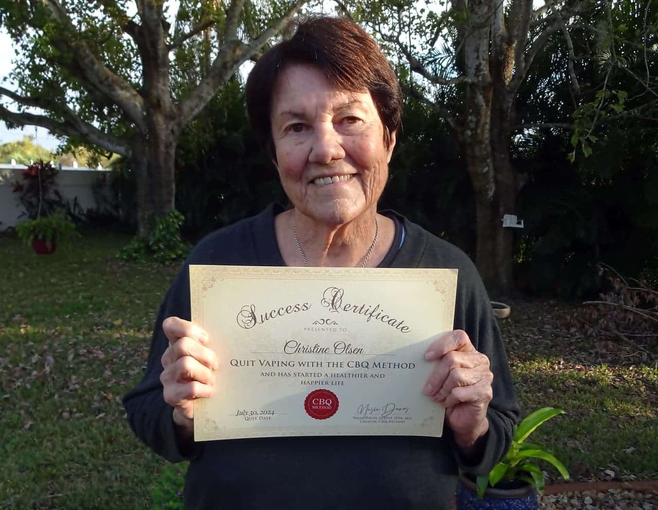 CBQ Nicotine Freedom Program Christine Olsen holding her CBQ Success Certificate