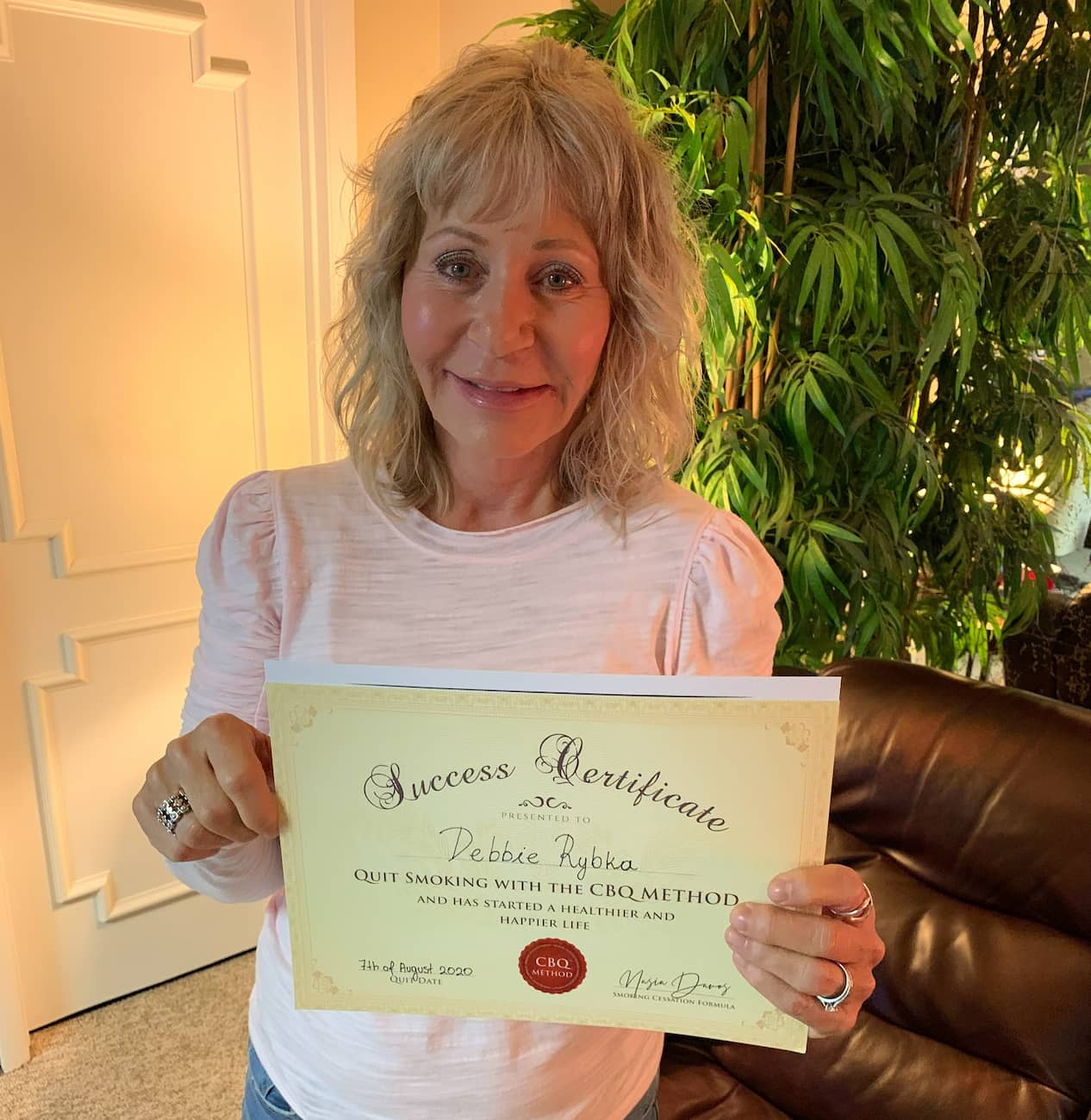 CBQ Nicotine Freedom Program member Debbie Rybka holding her CBQ Success Certificate