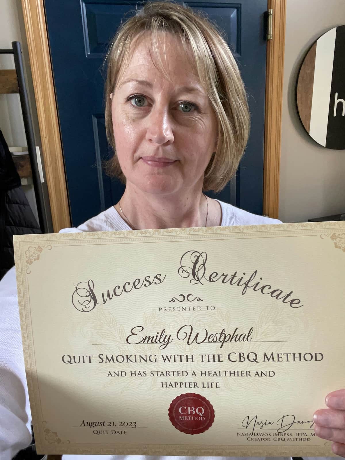 CBQ Nicotine Freedom Program member Emily Westphal holding her CBQ Success Certificate