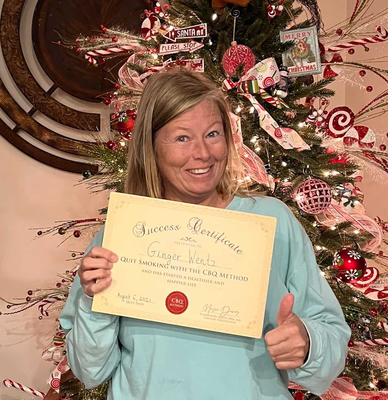 CBQ Nicotine Freedom Program member Ginger Wentz holding her CBQ Success Certificate