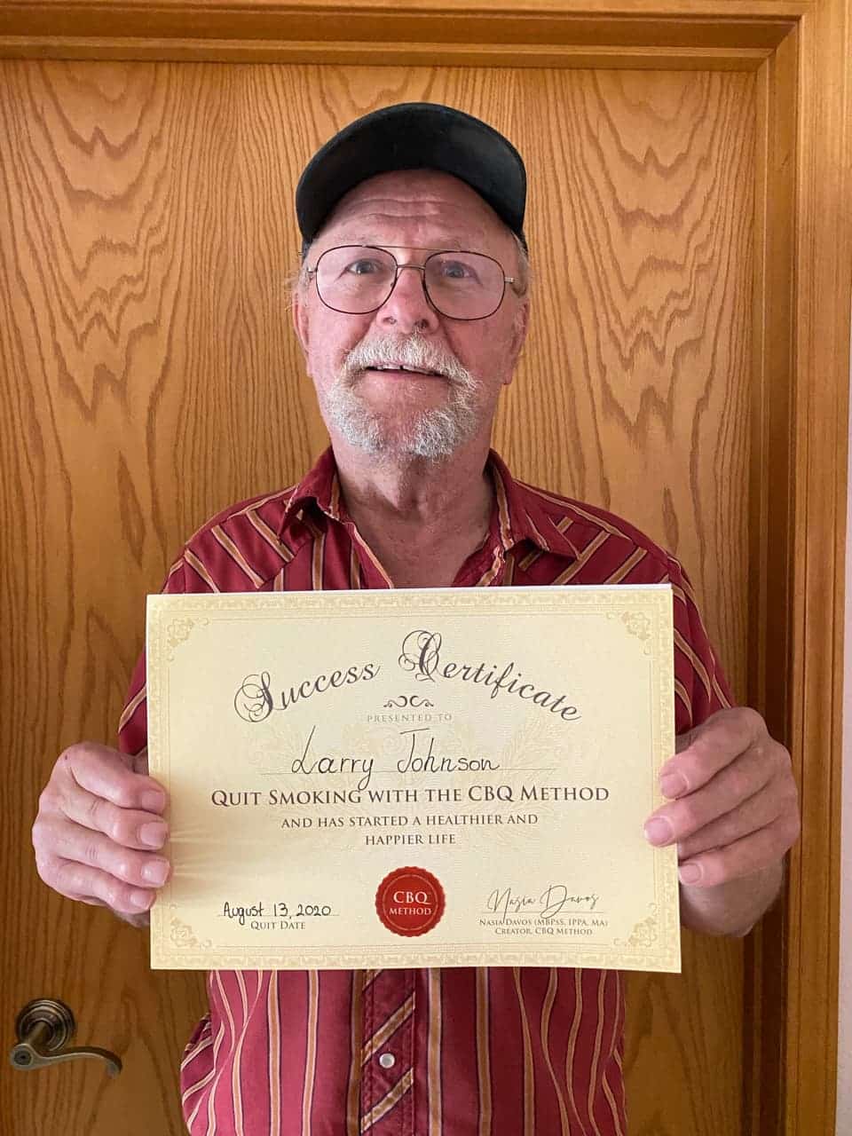 CBQ Nicotine Freedom Program member Larry Johnson holding his CBQ Success Certificate
