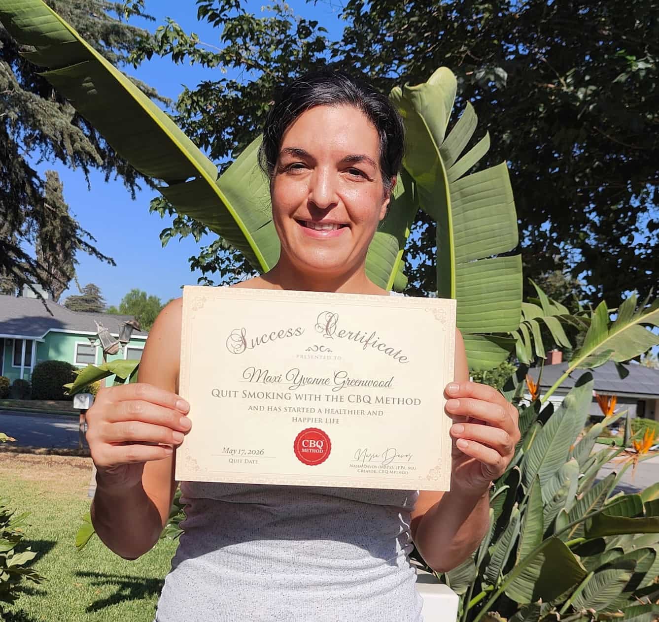 CBQ Nicotine Freedom Program member Maxi Greenwood holding her CBQ Success Certificate