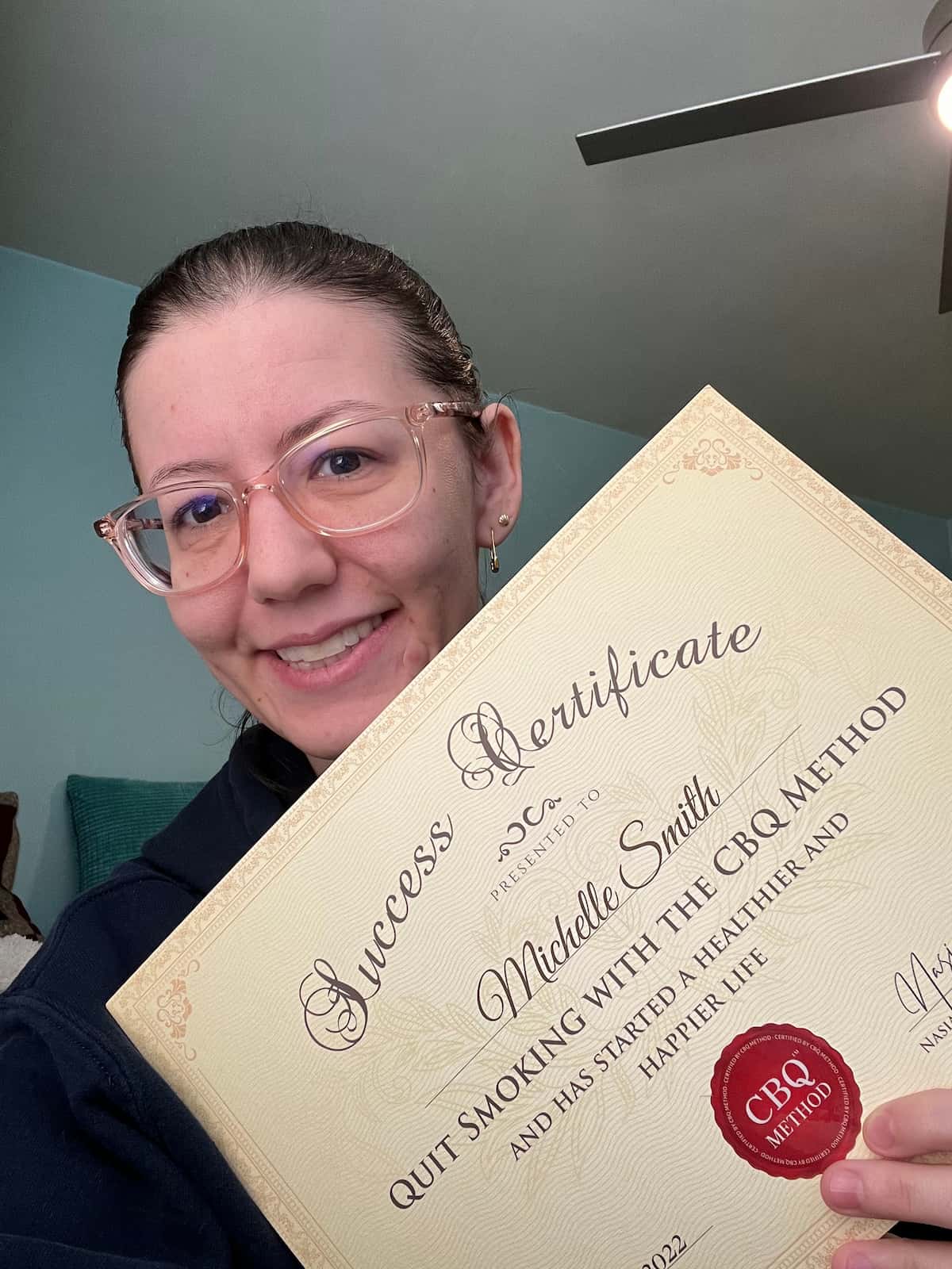 CBQ Nicotine Freedom Program member Michelle Smith holding her CBQ Success Certificate