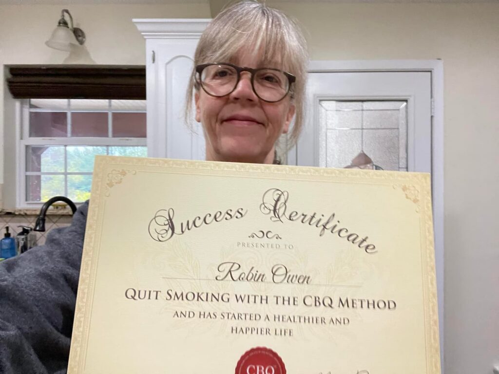 CBQ Nicotine Freedom Program member Robin Owen holding her CBQ Success Certificate
