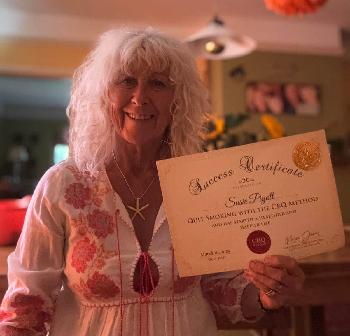 CBQ Nicotine Freedom Program member Susie Pigott holding her CBQ Success Certificate