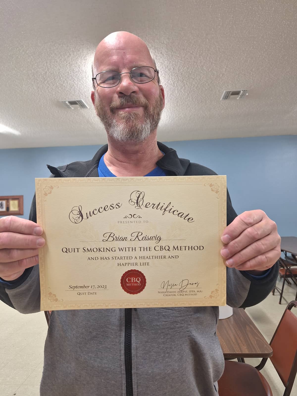 CBQ Nicotine Freedom Program member Brian Reiswig holding his CBQ Freedom Certificate