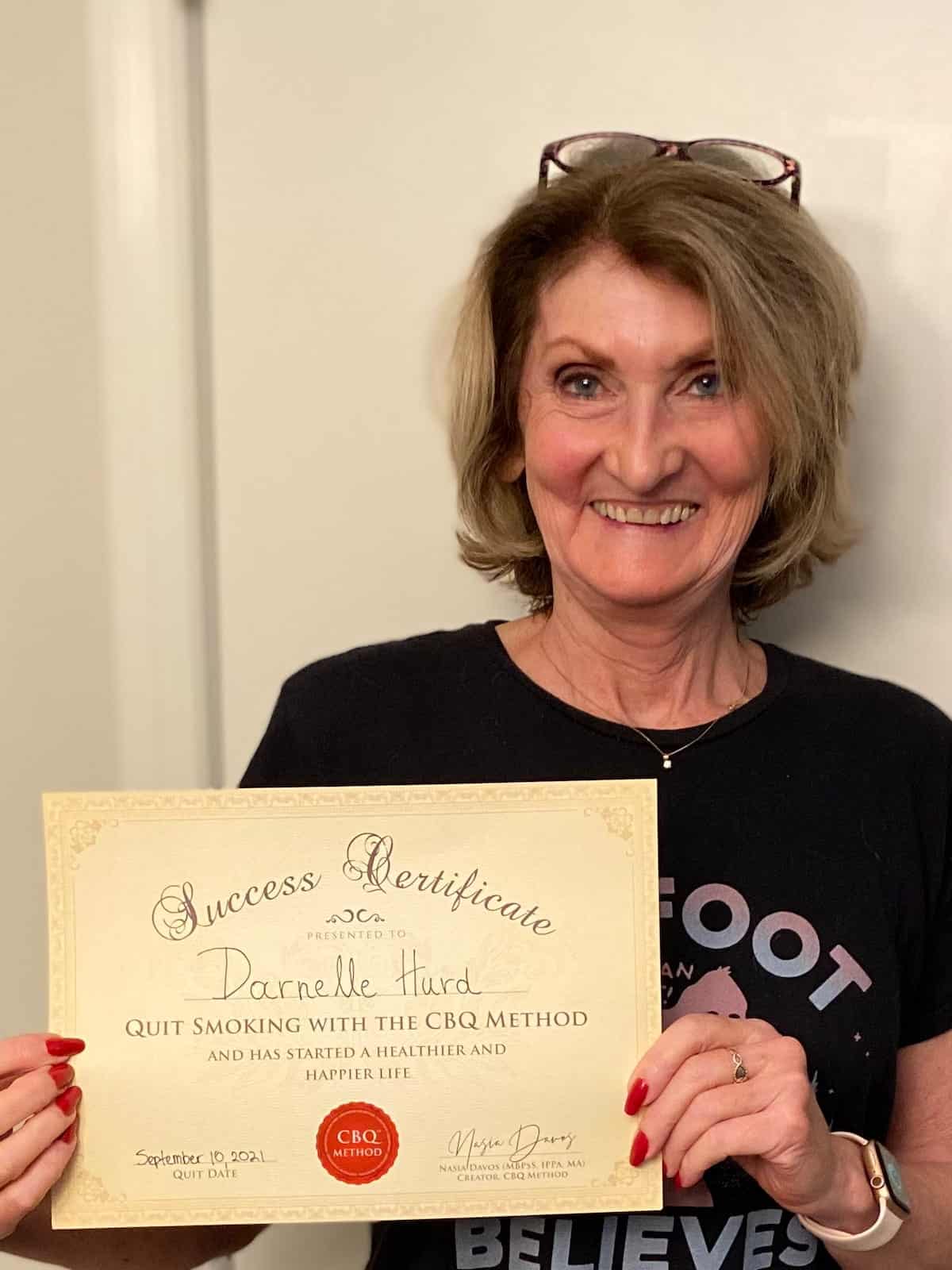 CBQ Nicotine Freedom Program member Darnelle Hurd holding her CBQ Freedom Certificate