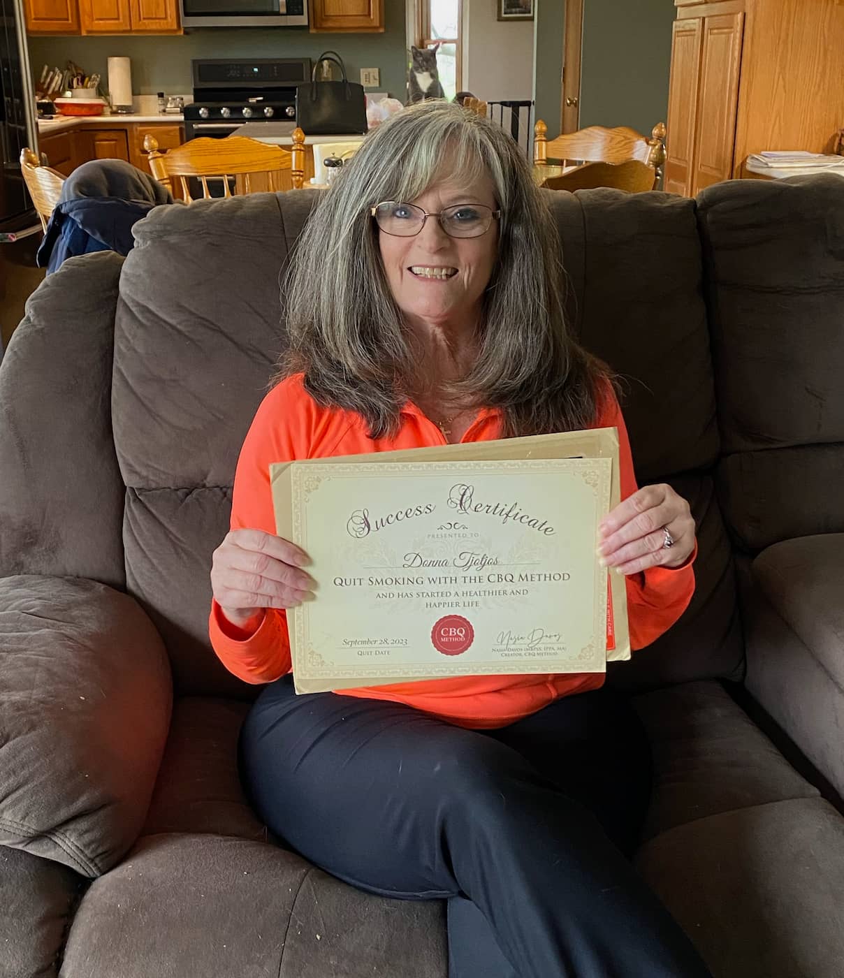 CBQ Nicotine Freedom Program member Donna Tjotjos holding her CBQ Freedom Certificate